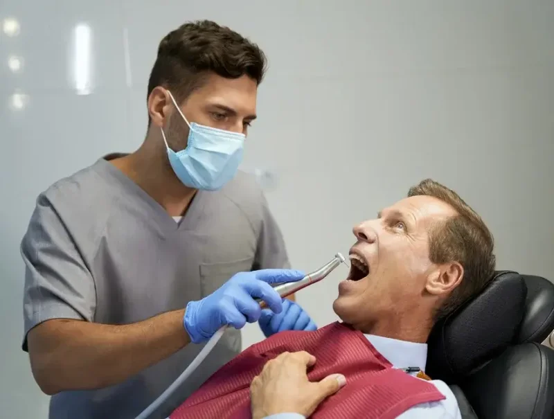 certified-dentist-treating-his-patient